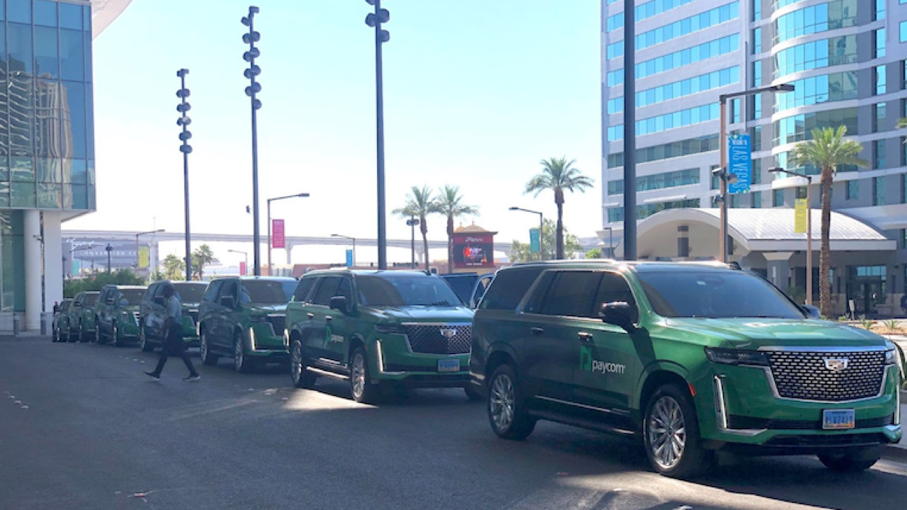a fleet of green SUVs outside the Las Vegas convention center
